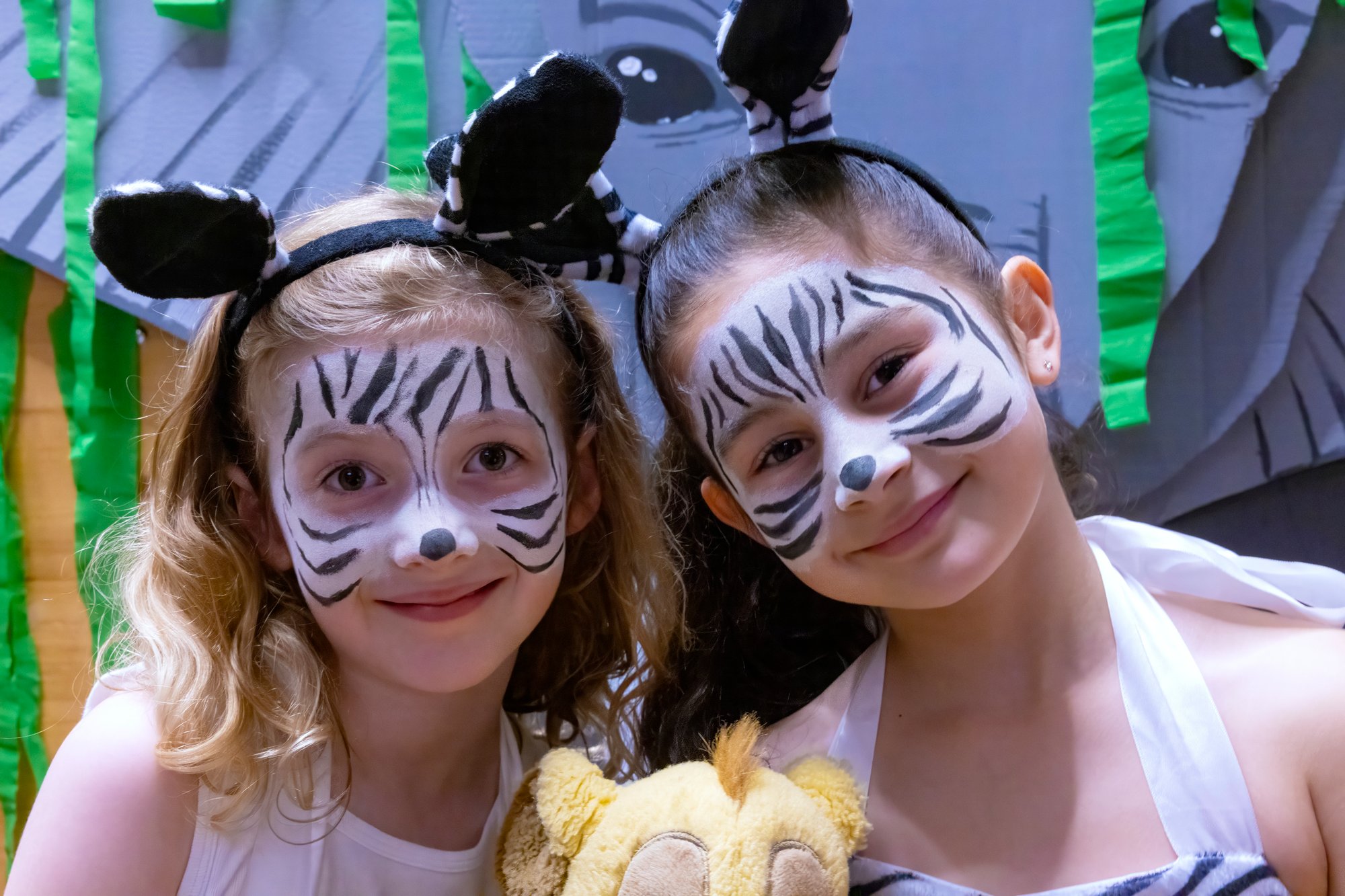 Two girls in costume pose to camera.