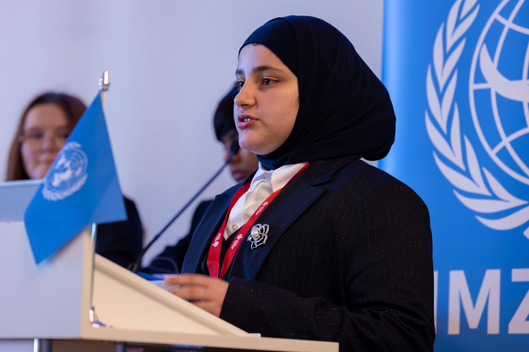 A female student with head cover hijab gives a speech at Institut Montana Model United Nations conference.