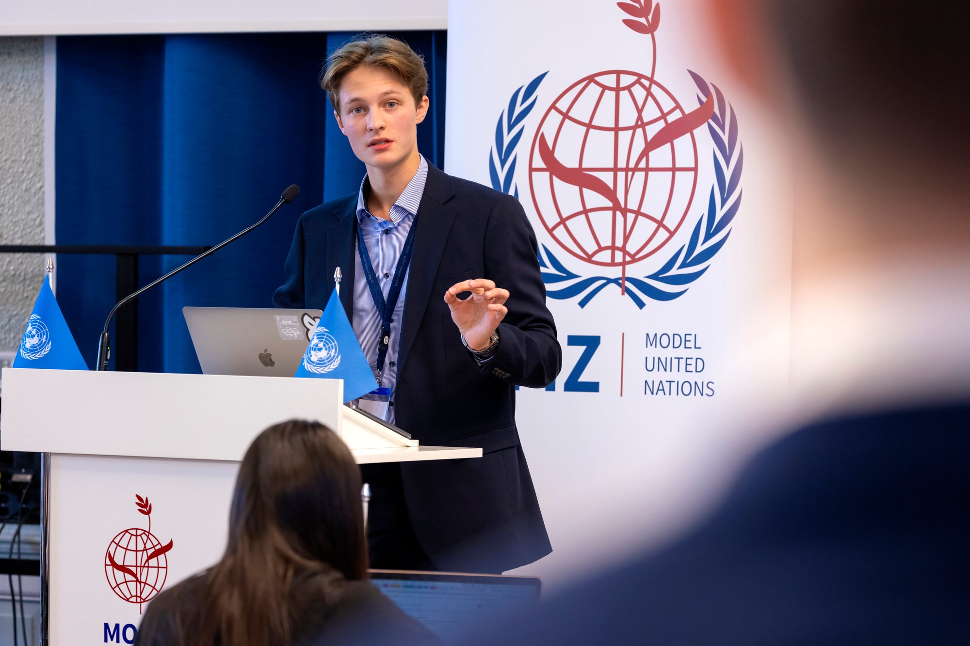 A male student speaks at a model united nations conference.