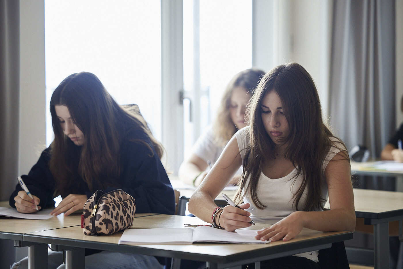 A group of female students in a class concentrating on their assignment.